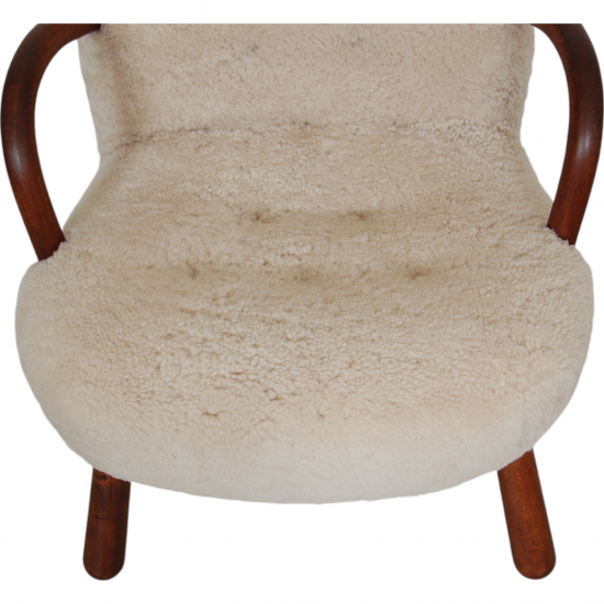 Clam chair reupholstered in sheepskin